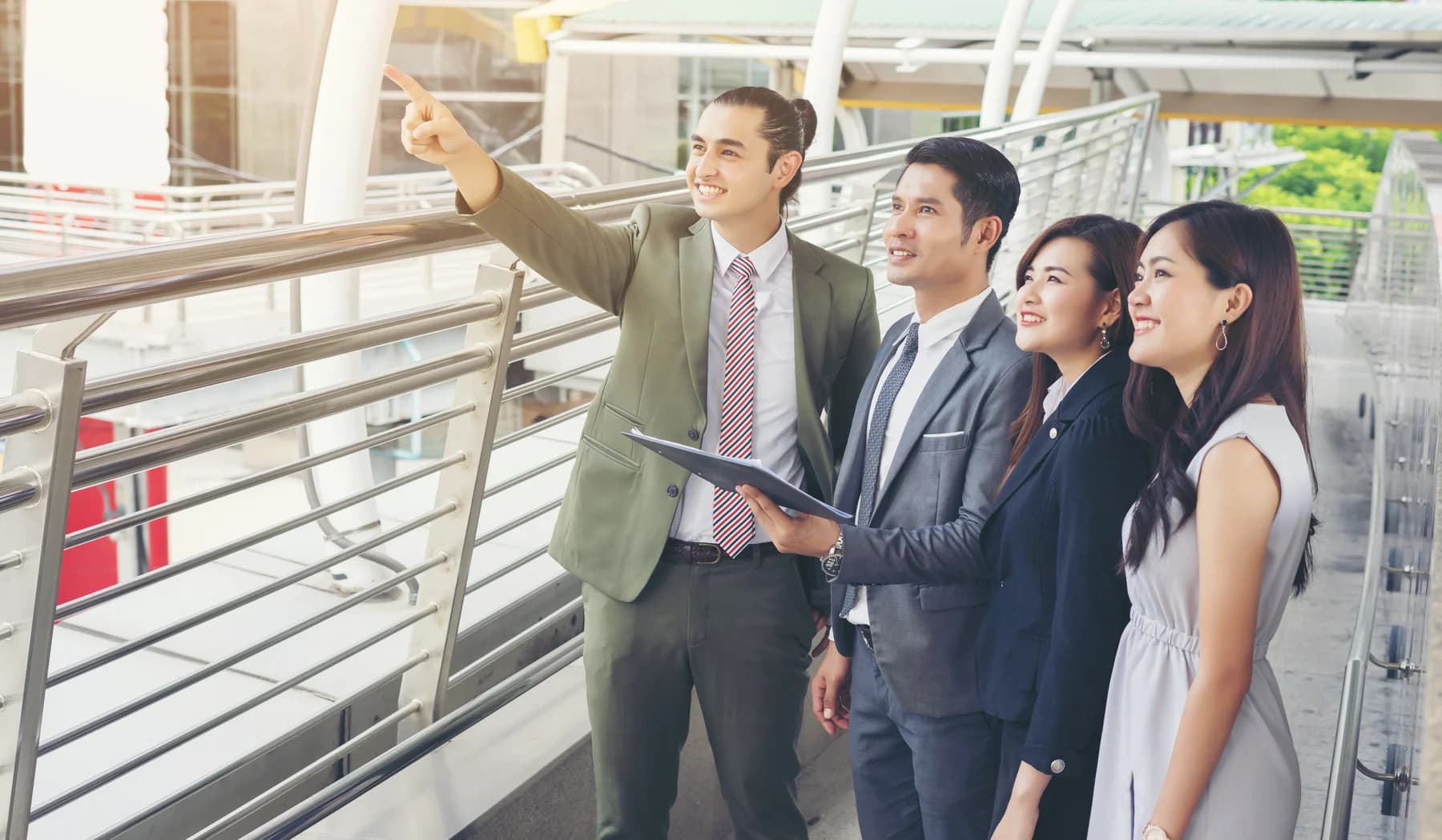 A group of Asian professionals touring a modern business complex